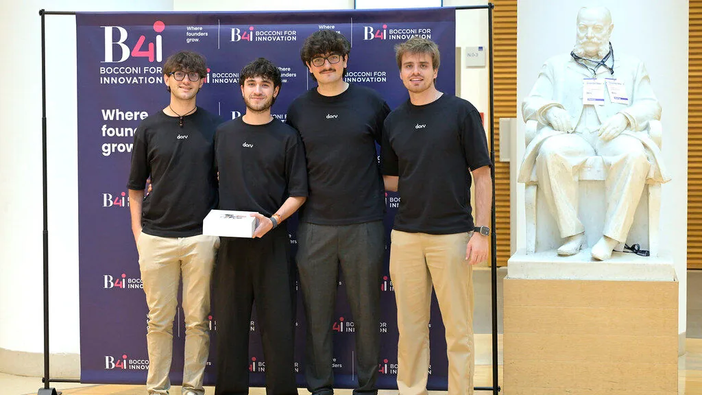 The four Dory founders in front of the B4i backdrop, one of them holding the product box.